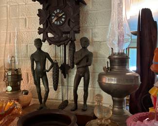 Antique cuckoo clock, statues, Aladdin oil lamp, carnival glass French poodle dish