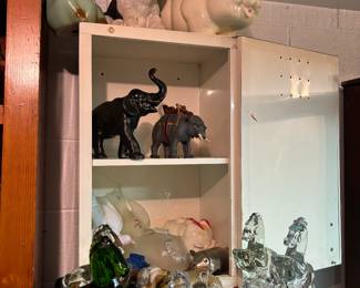 Antique piggy banks, viking glass horses, elephants, birds
