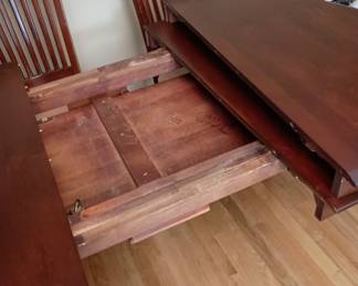 This Richardson Table can store the leaves within the table. 
The table is shown with one leaf in place