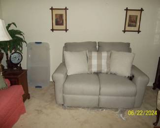 the gray loveseat is new and both sides recline