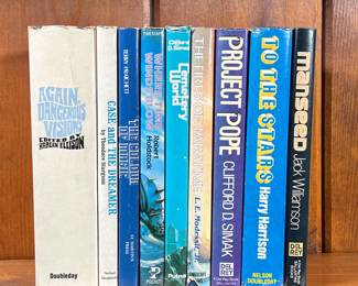 LOT OF SCIENCE FICTION BOOKS | Including: Manseed by Jack Williamson, To The Stars by Harry Harrison, Project Pope by Clifford D. Simak, The Fires of Paratime by L.E. Modessit, Jr., Cemetery World by Clifford D Simak, where time winds blow by Robert Holdstock, The Colour of Magic by Terry Pratchett, Case and the Dreamer by Theodore Sturgeon, Again Dangerous Visions by Harlan A Ellison. - l. 6 x w. 2 x h. 8-1/2 in