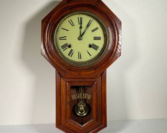 ANTIQUE DEA REGULATOR MECHANICAL WALL CLOCK | Mechanical wall clock in good condition with wind up key. -  l. 12 x w. 4-1/4 x h. 22 in

