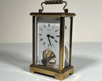 BULOVA 8-DAY BRASS CLOCK | Made in West Germany by Bulova Watch Company, carriage clock with 8-day movement in a beveled glass & brass case. - l. 3.25 x w. 2.25 x h. 6 in
