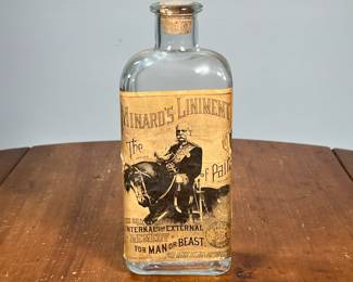 MINARD’S LINIMENT REMEDY BOTTLE | Apothecary bottle with old paper label mostly intact and in good condition; "the great internal and external remedy for man or beast for sale by all drug-ists". - h. 9.75 in

