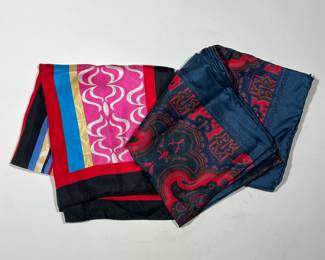 (2PC) SILK SCARVES | Including a scarf by Adrienne Landau Studio with contrasting pattern fields of loopy designs, geometrics, and shaped bands of rich color; the other a Burton Ltd scarf with of blue and red colors. - l. 34 x w. 34 in
