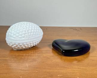 (2PC) TIFFANY & CO. GLASS PAPER WEIGHT | Blue glass heart paper weight by Tiffany & Co., and a white porcelain egg-shaped weaved basket designed by Sybil Connolly. -  l. 4-1/2 x w. 3 x h. 3 in

