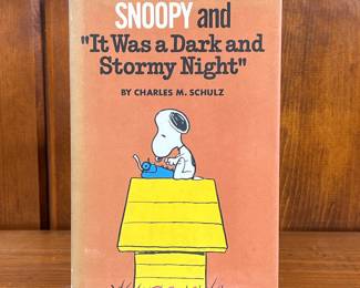 FIRST EDITION SNOOPY BY CHARLES M. SHULZ | Snoopy and "It Was a Dark and Stormy Night" by Charles M. Schulz, a hardcover book. - l. 5-1/2 x w. 8-1/4 in

