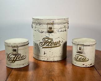(3PC) KREAMER BRANDED TINS | Round flour, coffee, and tea canisters with hinged lids marked KREAMER on the bottom. - l. 9-1/2 x w. 9-1/2 x h. 10-1/4 in