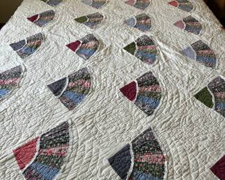 Handmade queen quilt on vintage bed with built-in bookcase 