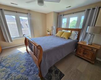 Queen size pine bed with wrought iron on Headboard and footboard. Has a pair of matching nightstands, Triple dresser with mirror, And chest of drawers