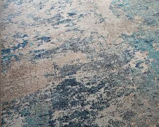 Five by seven area rug in aqua, navy , and gray Colors