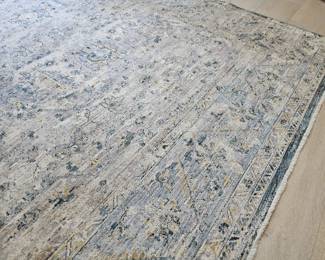 Room size contemporary carpet in light blues and cream colors