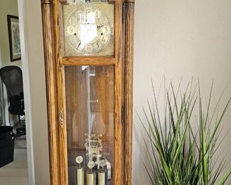 Vintage howard miller, oak grandfather clock with moon face, has four chimes and works perfectly