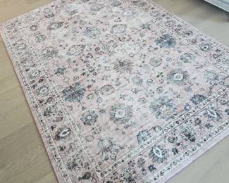 Washable area rug in pink and gray tones