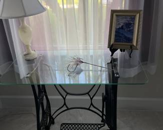 glass top table made from antique sewing machin