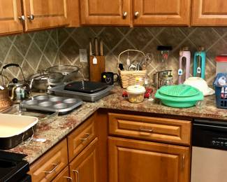 Kitchen bakeware, teapots, knife set, and miscellaneous, assorted utensils.