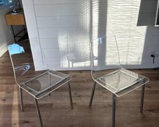 clear dining acrylic chairs with nickel legs Chiaro sold by CB2.