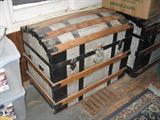 There are several beautiful old trunks.