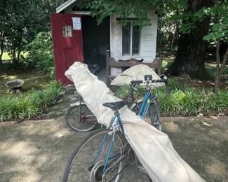 Small storage shed on the side is full of yard supplies as well.