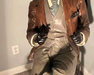 Lower Level:  A life-size polychrome man has been in the family for many years.  He was living in an old warehouse on Franklin Avenue in 1936 when our client's family purchased the building for their barber supply business.  He became a prominent spokesperson for the family business, and they named him "Waldo."  In the 1950's, a startled police officer walking the warehouse beat accidentally shot his fingers off.   Waldo moved with the family throughout the years, losing his left foot at one time.  Eventually, he was moved from the barber chair to the family dining chair where he still sits today.  He has been a part of the family for over 90 years but does not wish to make the move to Kansas City--he prefers to stay in in St. Louis.  He will be homeless soon.   The next photo shows a close-up of his face.  