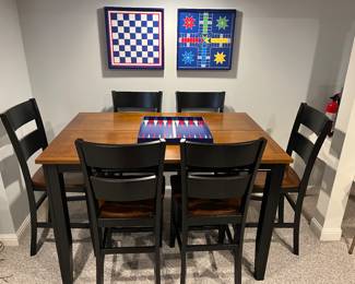 Lower Level:  The counter height table  measures 54" x 36" x 36" tall and has one additional 18" leaf.  It is priced with six armless counter height chairs.  The next photo shows one of the chairs.  The board games with their respective game pieces are also for sale.