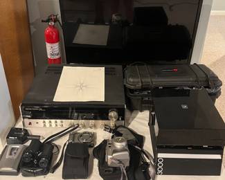 Lower Level:  More electronics:  a 31" LG tv (2013); Harman/kardon 730 twin powered receiver and manual (see next photo); cameras; binoculars; hand held cassette recorder; a Simmons 20x60 spotting  scope in case with tripod; and a Bell & Howell 3000 slide projector.