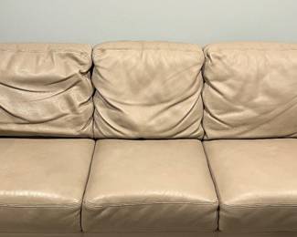 Lower Level:  This is a closer view of the taupe leather sofa which has three attached back cushions and three attached seat cushions.