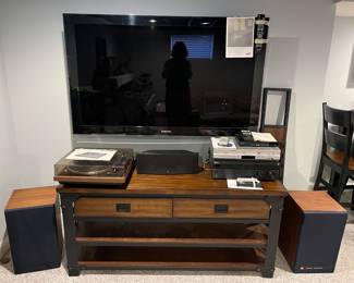 Lower Level:  A 55" SAMSUNG Series 6 flat screen TV (2009) with remote and manual is for sale but its wall bracket is not.  The other electronics shown are:  a pair of JBL Model 4301B speakers; vintage DUAL 502 Belt Drive Turntable; one BOSTON Center Sat 7 speaker;   SONY Blue-Tooth DVD Player with manual; SAMSUNG DVD/VHS Combo V4600 with manual and remote;  and a SONY Model STR-DH790 multi-channel AV Receiver with manual and remotes. The stand is also for sale and has two drawers and two shelves. Extra pieces are nearby.  See the next photo.