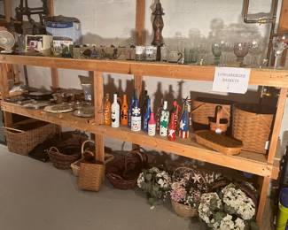Lower Level:  An assortment of items are displayed, including Franklin Mint pewter figures (see next photo); painted decorative bottles; baskets (some Longaberger); and glassware.