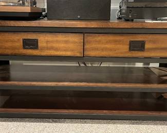 Lower Level:  The sturdy wood/metal tv stand has two upper drawers and two shelves.  There is extra hardware and supports to mount a tv on the unit.  It measures 56" wide x 18-1/2" deep x 26" tall.