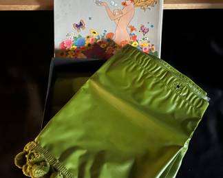 Lower Level:  An avocado green vinyl SEARS shower curtain panel, ball fridge valance, and ball fringe tie back are included with its original box.