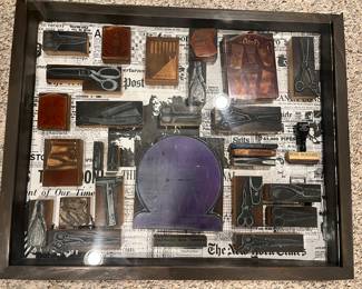 Lower Level:  A shadow box displays various copper printer blocks related to the barber business.  The glass top slides open.  It measures 21-1/2" x 17-1/2."