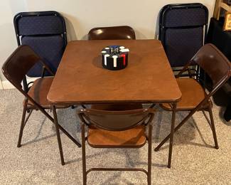 Lower Level:  A folding table and four matching folding chairs are priced as a set.  The poker chips are also for sale.  Against the wall is a set of four upholstered folding chairs.  