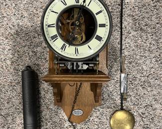 Lower Level:  A West Germany made "Tempos Fugit" skeleton 8-day clock has been mounted on a wooden wall shelf.  Its weight and pendulum are included.
