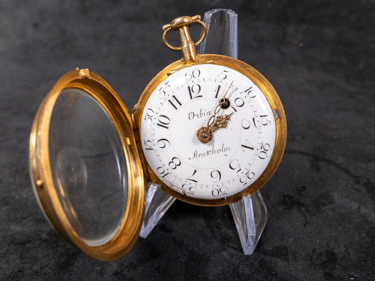 An 18K gold pocket watch with an enamel face with both hour and minute Arabic numerals. Made by watchmaker Carl Erick Orbin of Stockholm Sweden. Circa late 1700's. The back of the movement is engraved "Carl Er. Orbin", "Stockholm", and "No. 188". No key.