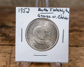 A 1952 50C Washington-Carver commemorative half-dollar. Great details and luster. Estimated UNC condition.