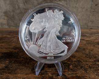 A 2013 4 Troy Ounce Silver Bullion Coin. The back of the coin is marked One Quarter Pound Fine Silver.