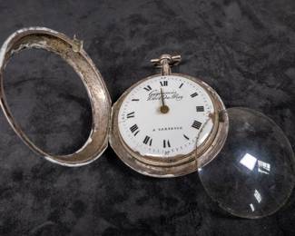 A silver pocket watch and silver case with an enamel face and Roman numerals. Made by watchmaker Gugenmus Horloger Du Roy of Warsaw, Poland. Circa 1790's. The face and back of the movement are both marked with the makers name. The back of the movement had a unique glass cover. The interior hinge is missing the pin and the outer glass cover is loose.
