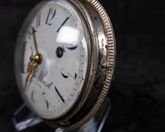 A silver pocket watch with an enamel face and Arabic numerals signed on the face "John Ward LONDON", made by watchmaker John Ward of London, late 18th Century. The movement on the back is signed "John Ward Fore Street London" Number 2640. The back movements shows a monogram of King George III, with two "G"s one reversed, and the Roman numerals III with a crown affixed on top.