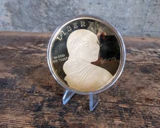 A 4 Troy Ounce Silver Sacagawea Dollar plated in 24k Gold.