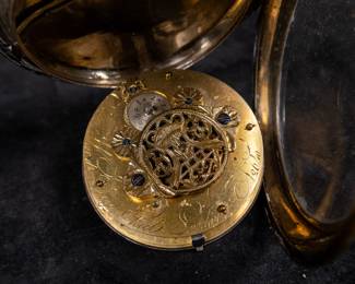 A silver pocket watch with an enamel face and Arabic numerals signed on the face "John Ward LONDON", made by watchmaker John Ward of London, late 18th Century. The movement on the back is signed "John Ward Fore Street London" Number 2640. The back movements shows a monogram of King George III, with two "G"s one reversed, and the Roman numerals III with a crown affixed on top.