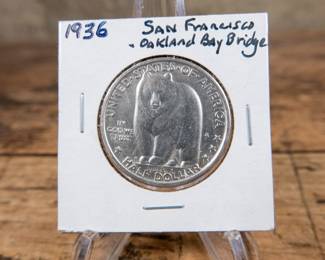 A 1936 50C Bay Bridge San Francisco-Oakland commemorative half-dollar. Great luster and excellent details. Estimated high UNC condition.