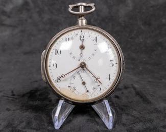 A silver pocket watch in a silver case, with an enamel face and Arabic numerals. Made by Thomas De Lasalle circa late 1700's. The back of the watch movement is engraved "J. De Lasalle London" and "1329".
