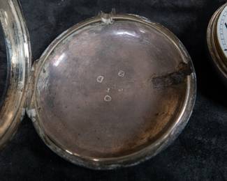A silver pocket watch in a silver case, with an enamel face and Arabic numerals. Made by Thomas De Lasalle circa late 1700's. The back of the watch movement is engraved "J. De Lasalle London" and "1329".