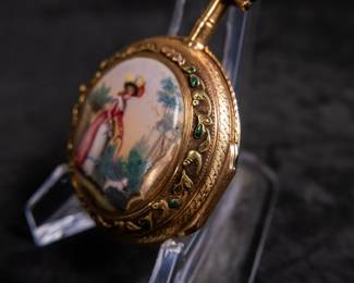 An 18K gold pocket watch with an enamel face and both Roman and Arabic numerals, and an artistic enamel back. Made by watchmaker Jean Romilly circa 1780-1790. The face and back of the movement are both inscribed "Romilly A PARIS"