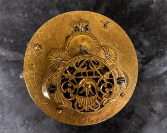 A silver pocket watch in a silver case with an enamel face and Arabic numerals, made by watchmaker John Ward of London, Late 18th Century. The movement on the back is signed "John Ward Fore Street London" Number 2690. The back movements shows a monogram of King George III, with two "G"s one reversed, and the Roman numerals III with a crown affixed on top. This watch is missing it's glass cover, and has a damaged hinge and watch hand.