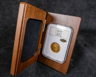 An 1823 $5 Capped Bust Half-Eagle Gold Coin. Graded an AU-50 by NGC. This coin also has a CAC Gold Sticker, meaning CAC believes the quality of the coin may warrant a higher grade. It is estimated there are 80 to 100 surviving examples of this coin. The design features are well brought up in most areas. The semi-reflective green-gold surfaces display pleasing coral color near the peripheries.