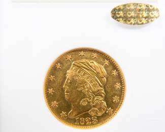 An 1823 $5 Capped Bust Half-Eagle Gold Coin. Graded an AU-50 by NGC. This coin also has a CAC Gold Sticker, meaning CAC believes the quality of the coin may warrant a higher grade. It is estimated there are 80 to 100 surviving examples of this coin. The design features are well brought up in most areas. The semi-reflective green-gold surfaces display pleasing coral color near the peripheries.
