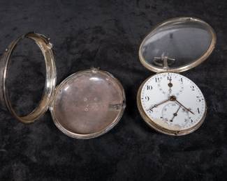A silver pocket watch in a silver case, with an enamel face and Arabic numerals. Made by Thomas De Lasalle circa late 1700's. The back of the watch movement is engraved "J. De Lasalle London" and "1329".
