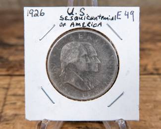 A 1926 50C U.S. Sesquicentennial commemorative half-dollar. Estimated XF-AU condition.